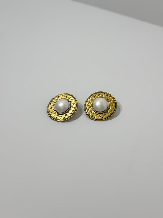 Front Angle: handmade earrings featuring artfully sculpted clay to resemble a central pearl encircled by bold, textured gold details.